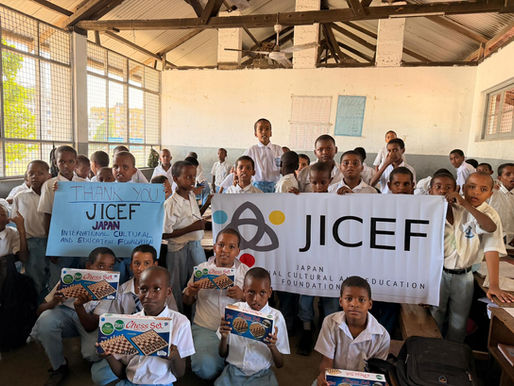 ケニアの孤児院で、JICEF（日本国際文化教育財団）の横断幕を掲げ、寄贈されたチェスセットを手にして笑顔を見せる多くの子どもたちの集合写真。