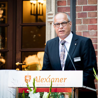Event-Reportage: Portraitbild vom Redner auf der Bühne.