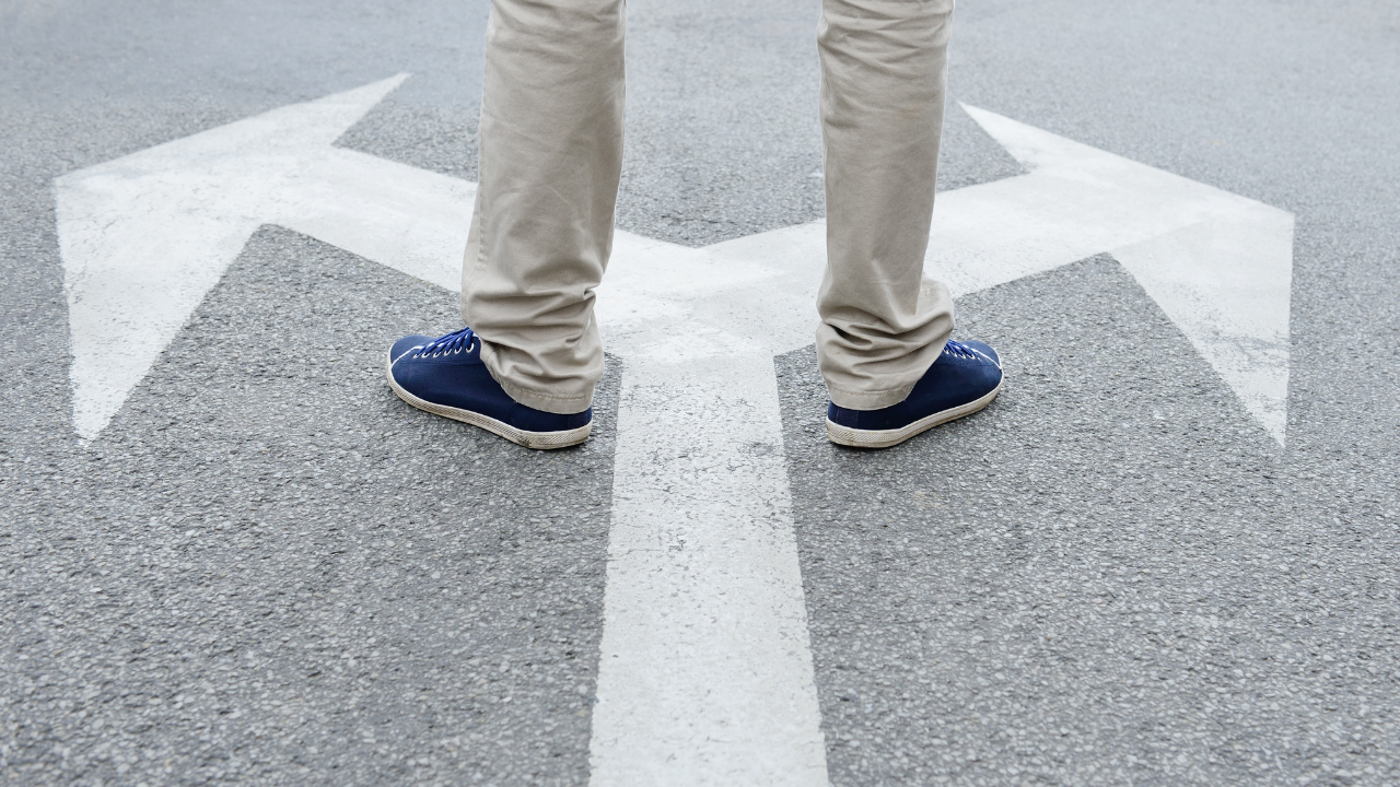 Person at crossroads, deciding between business automation with AI paths.