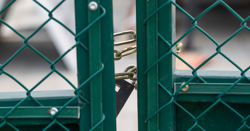 Symbolizing vendor lock-in with a padlock and chains securing a gate, representing restricted access and limited flexibility in IT solutions.