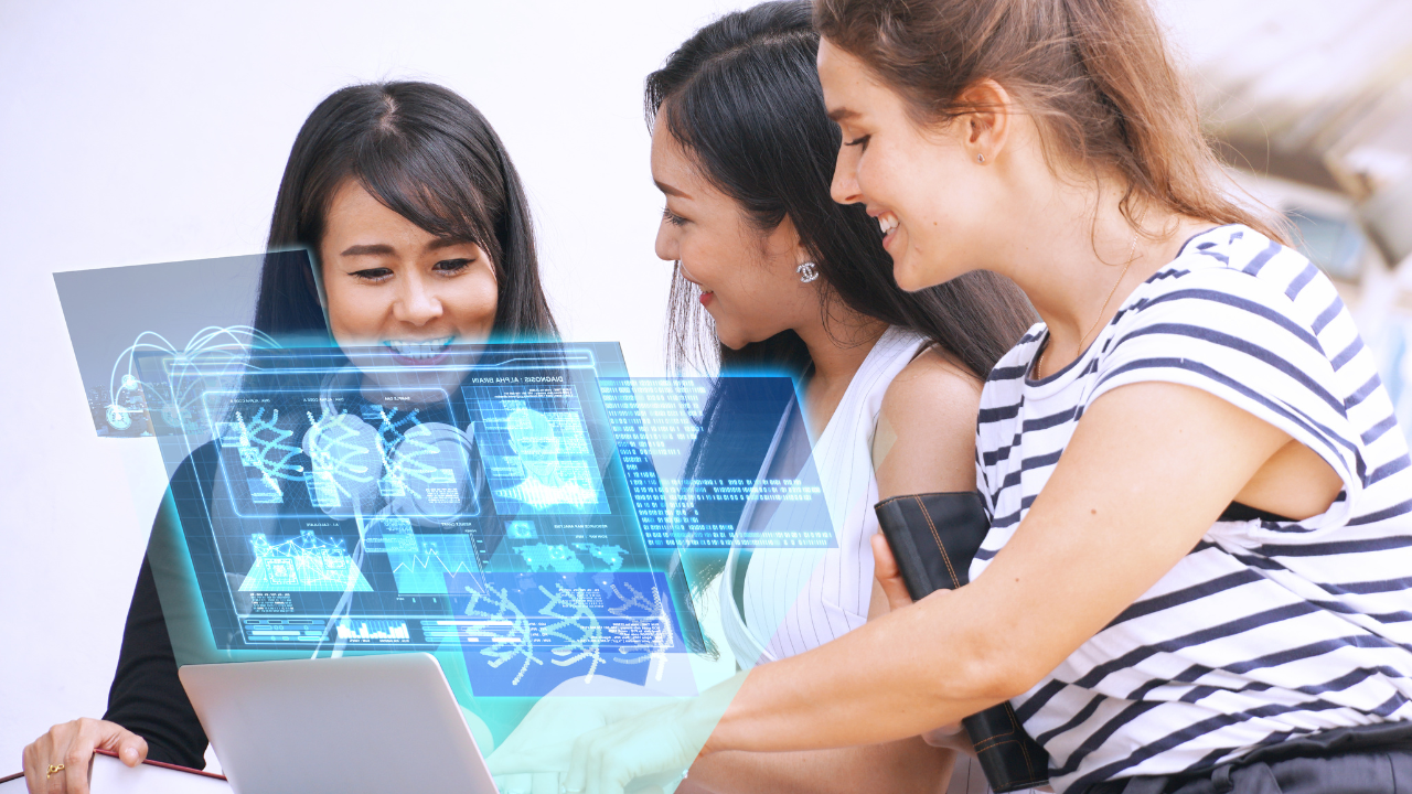 Women using laptop with holograms, exploring AI in customer care solutions.