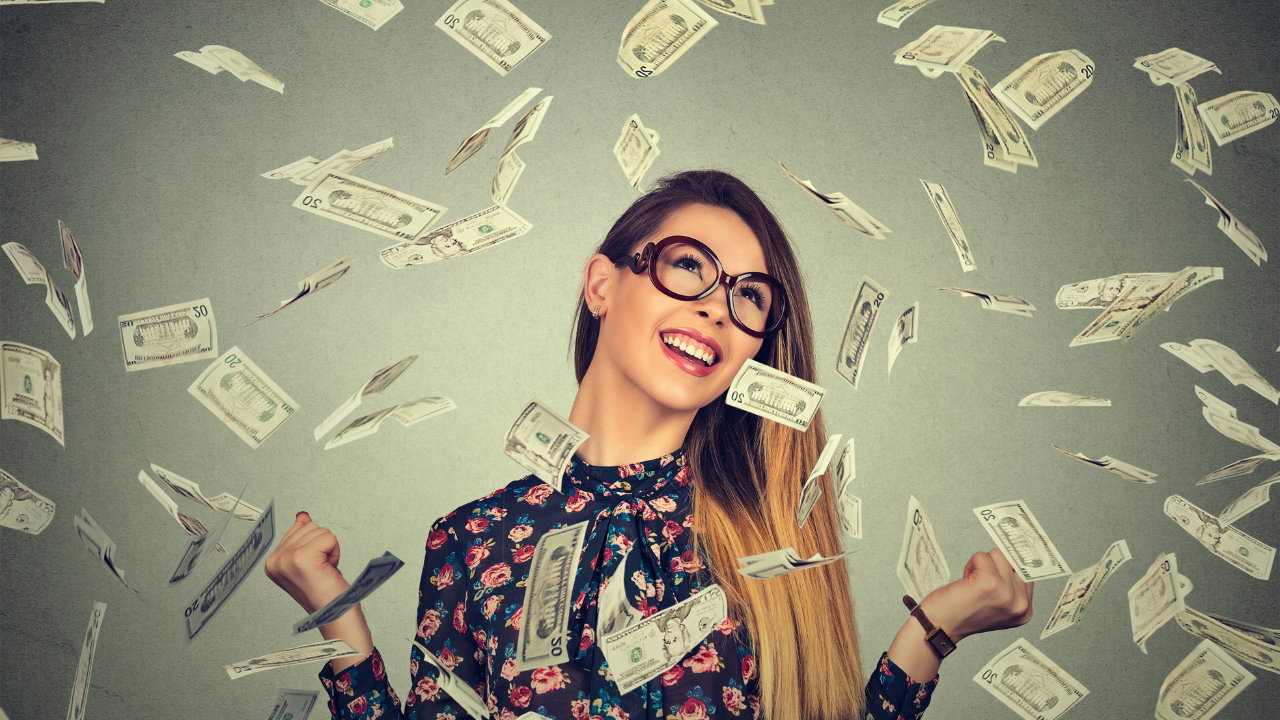 Smiling woman surrounded by falling cash, symbolizing AI economic impact and financial opportunity.