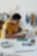boy-wearing-yellow-shirt-while-writing-o