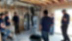 A candid shot capturing our company's owner, project manager, and team leads in a collaborative meeting within an unfinished basement of a Rapid City, SD home. Demonstrating our dedication to every project, from conception to completion.