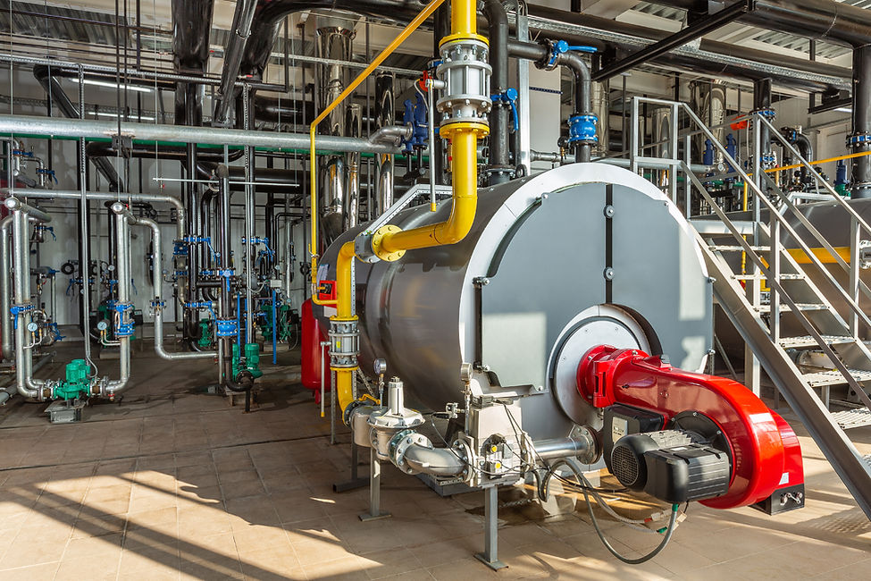 Interior of an industrial boiler room with boilers, many pipes, valves and sensors..jpg