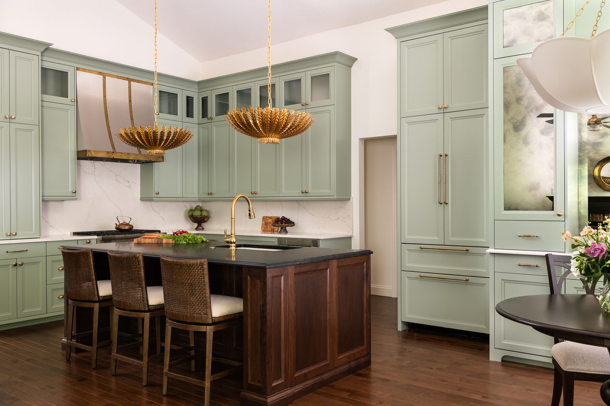Luxury kitchen with sage green cabinets, gold fixtures, and dark wood island designed by Alexa Stellern Design in Wildwood MO.