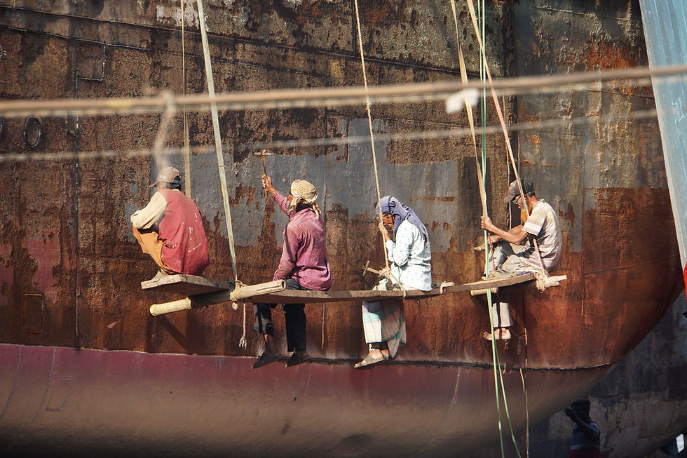 People painting ships in Bangladesh