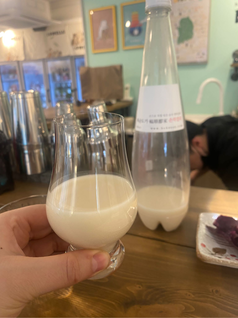 A tasting glass of cloudy Korean liquor, Makgeolli