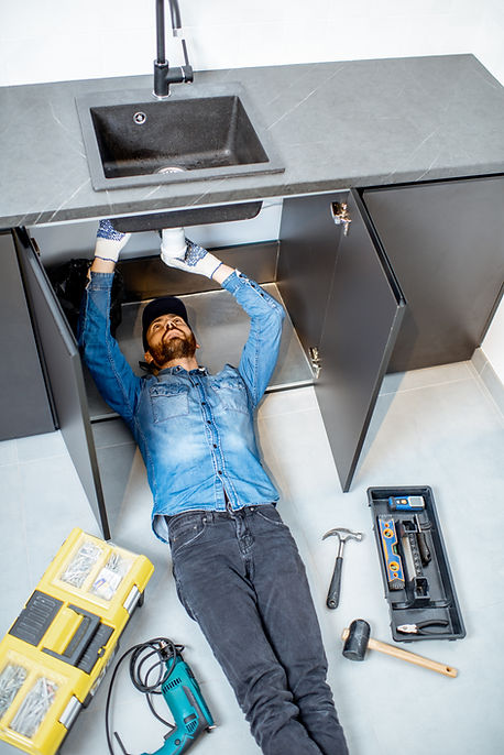 man-repairing-kitchen-plumbing-2021-11-02-00-20-05-utc.jpg