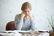 portrait-tired-student-woman-desk.jpg