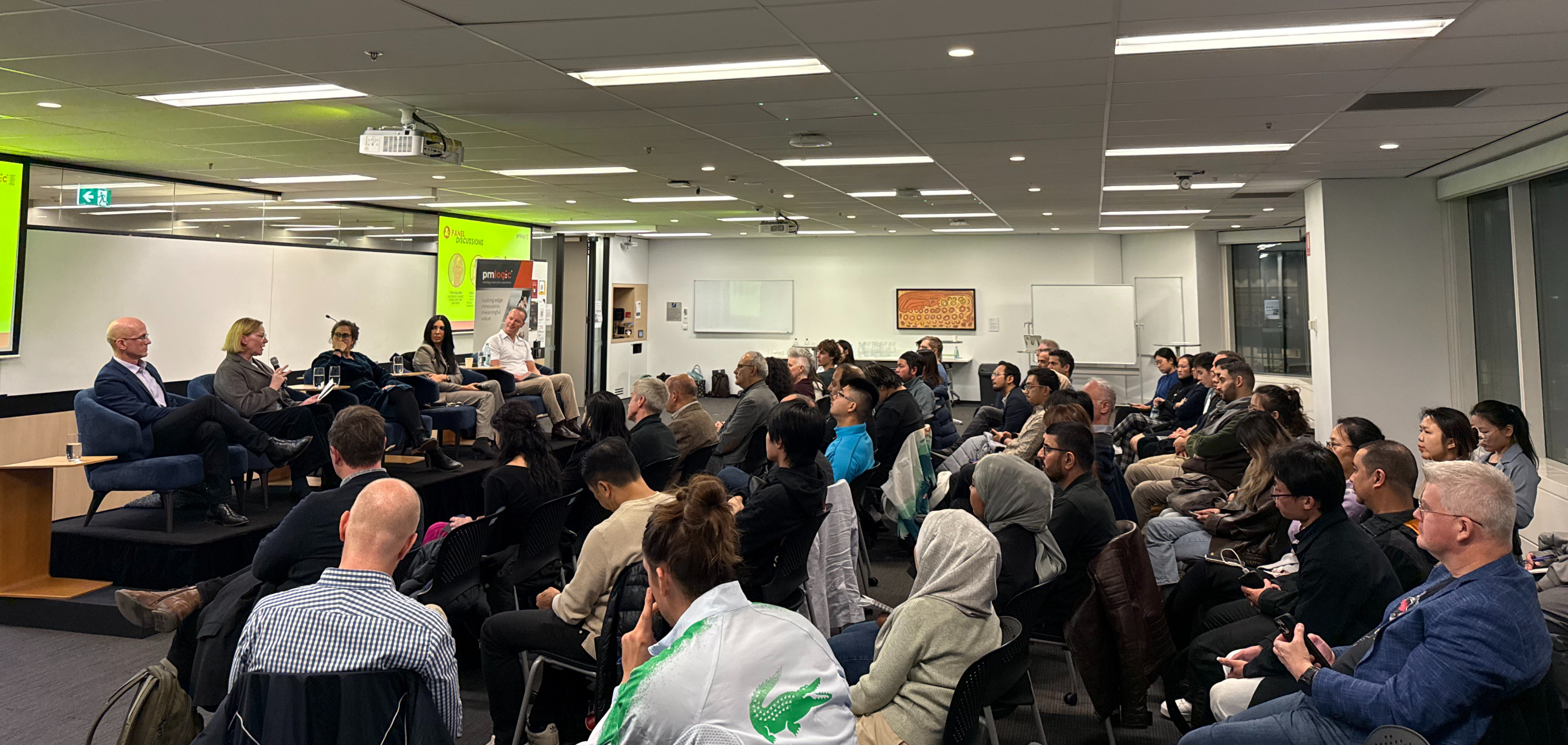 Professionals learning together at a PMLogic event