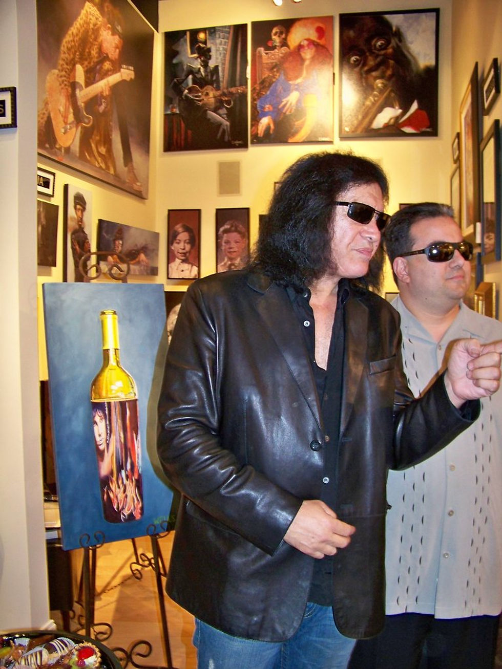 Gene Simmons  in front of Stacey Wells art