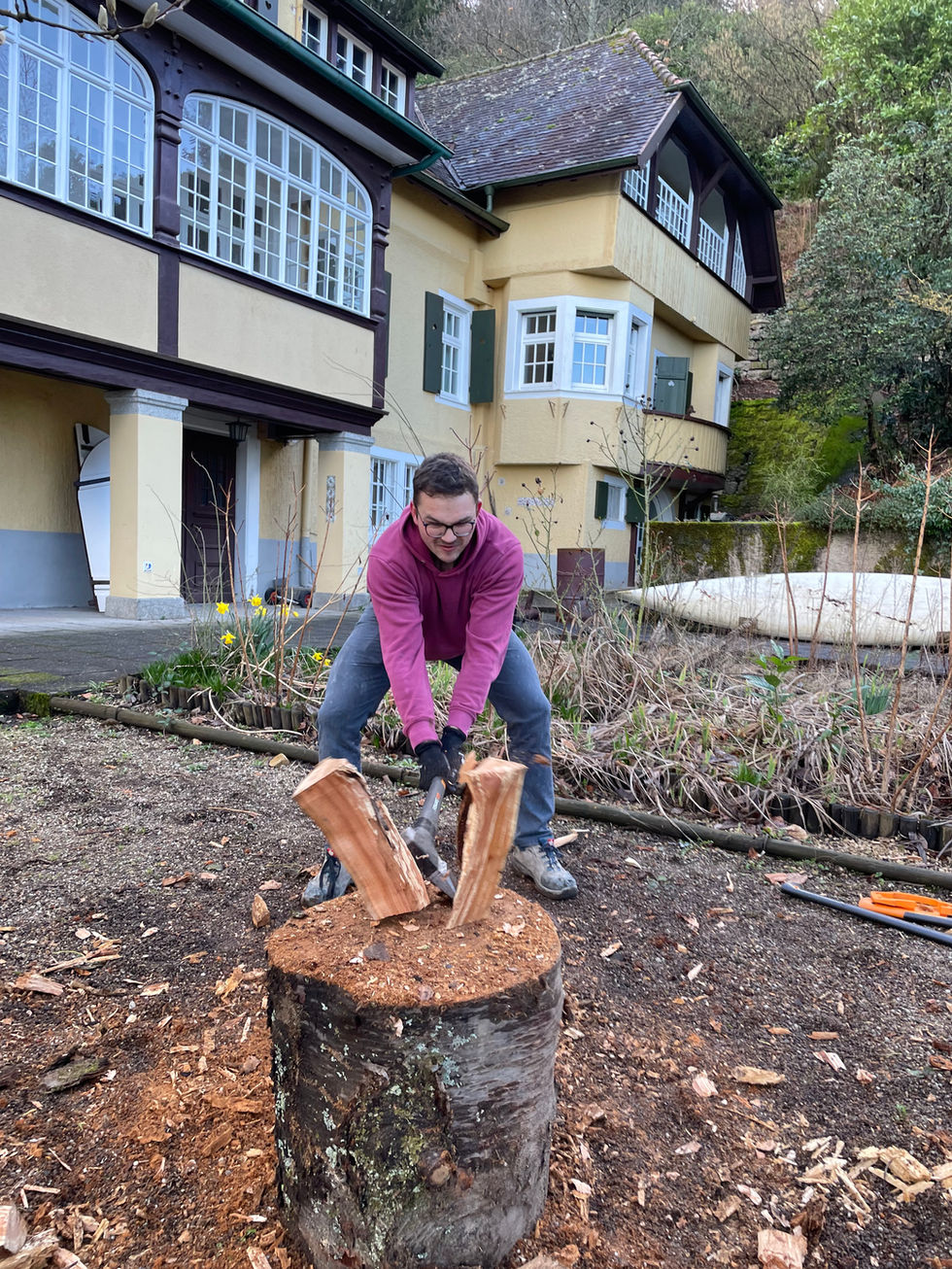 Mitarbeiter der sozialen Einrichtung nutzt Holzspalter zur Brennholzproduktion. Effiziente und sichere Arbeit im Rahmen der R