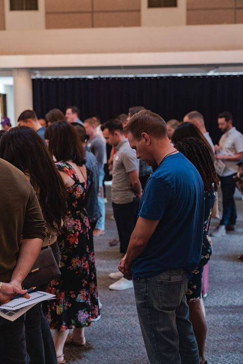 Christian singles praying before christian singles event starts