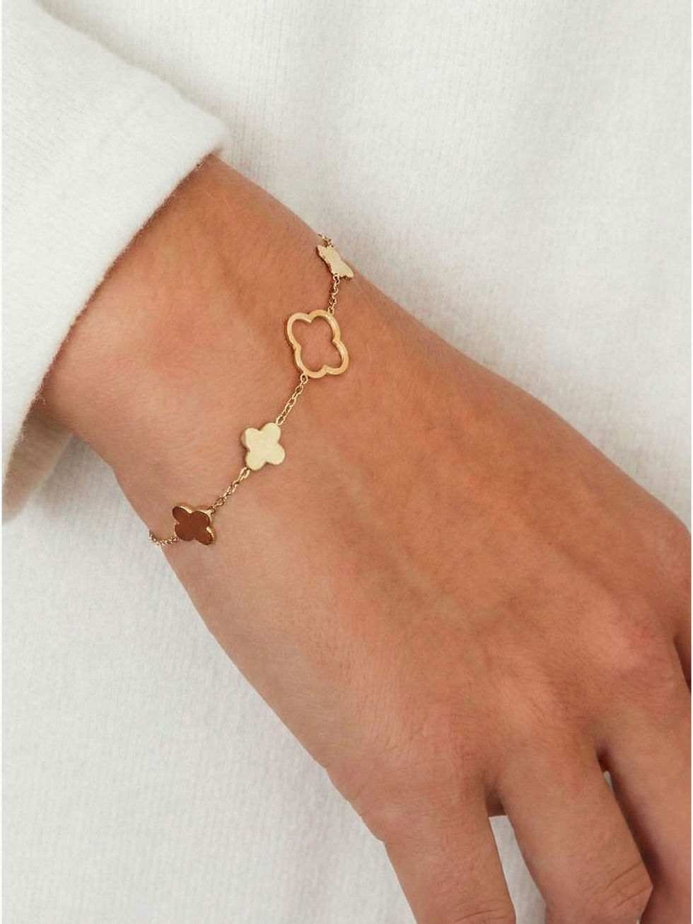 Elara Armband in Gold am Handgelenk getragen – Filigranes Kleeblatt-Design aus wasserfestem Edelstahl.