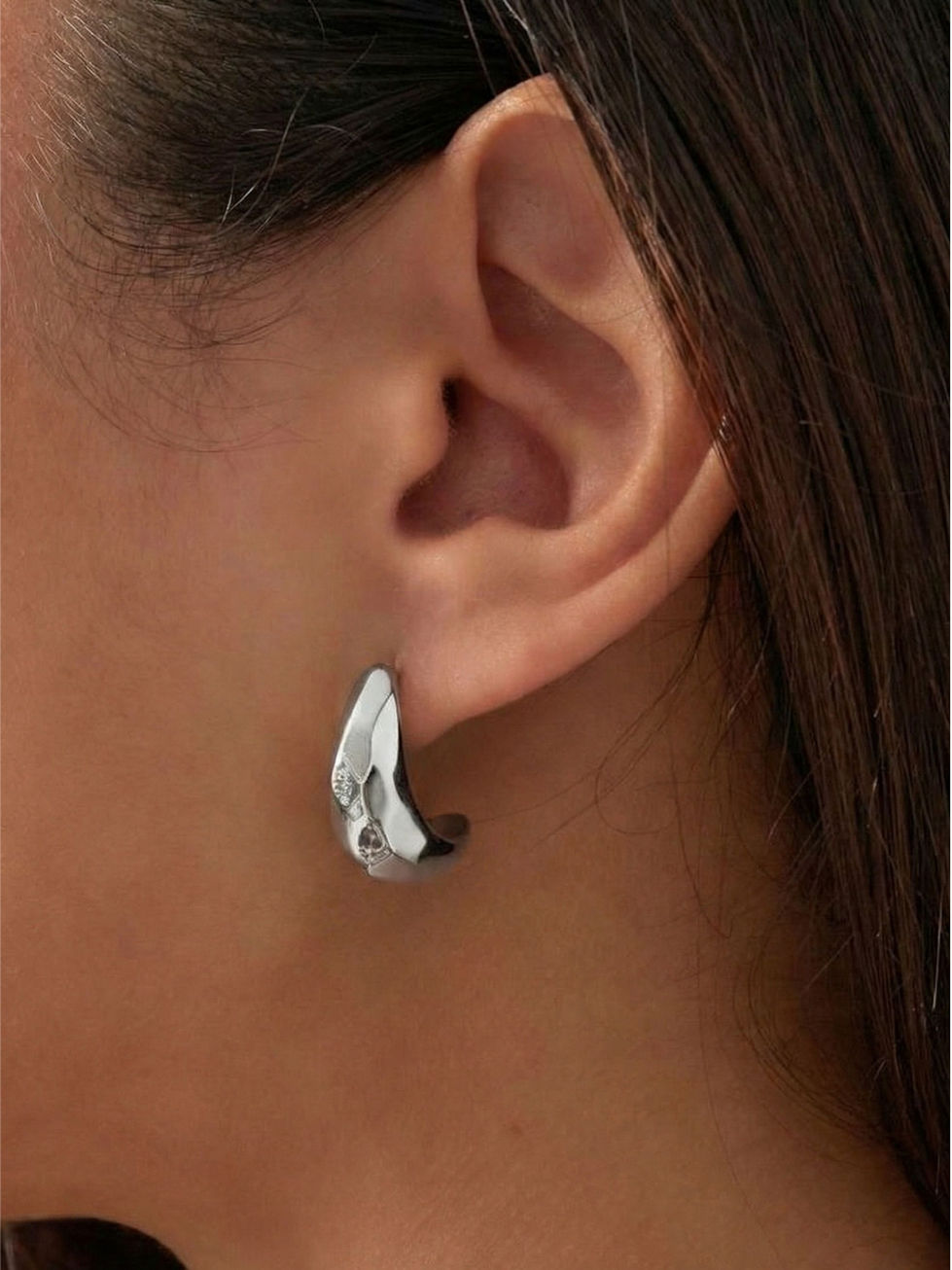 Die silberne Variante der Lana Ohrringe am Ohr – zeitloser, massiver Edelstahlschmuck für moderne Looks.