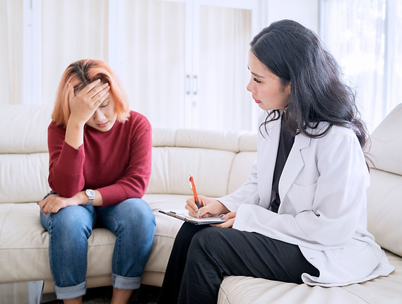 Psychologist Listening to Distressed Woman During Therapy Session.jpg