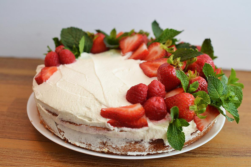 Easy Yogurt Cake topped with Whipped Cream & Berries