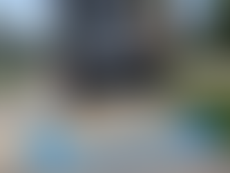 Dump truck delivering a load of sand onto a driveway in Winnipeg for landscaping project