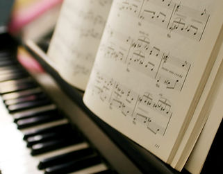 Blurred piano keys and sheet music