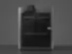 Bambu Lab 3D printer sitting on a dark table, representing professional custom 3D printing services.