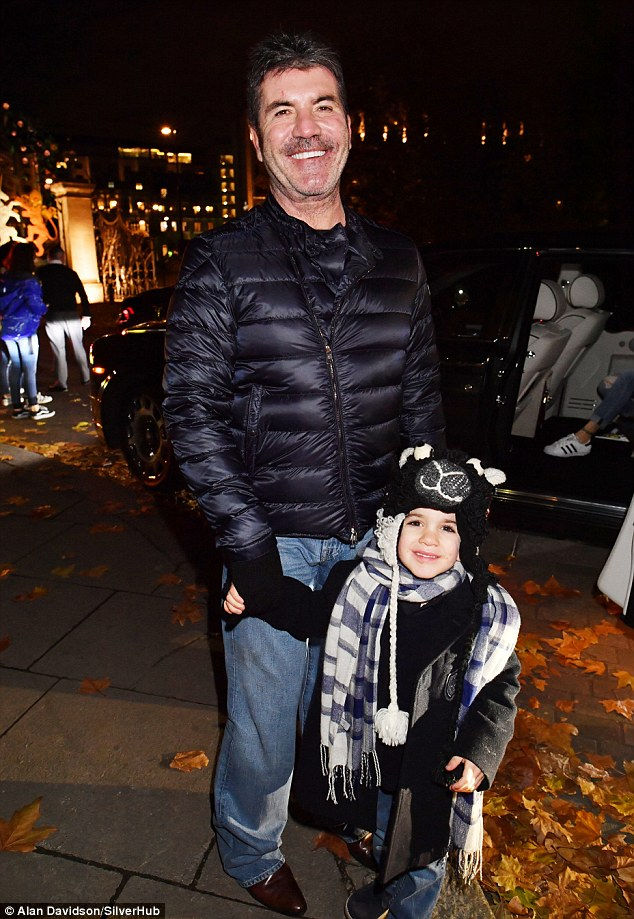 Simon Cowell with girlfriend Lauren Silverman and son Eric at Winter Wonderland in Hyde Park London
