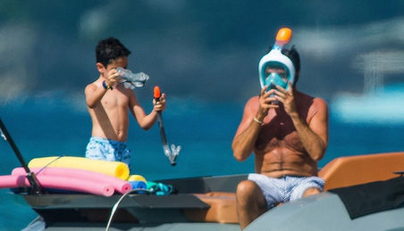 Simon Cowell takes Lauren, Eric AND the dogs on a boat trip in Barbados
