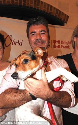 Simon Cowell and Lauren Silverman take their son Eric to the K9 friends charity in Barbados