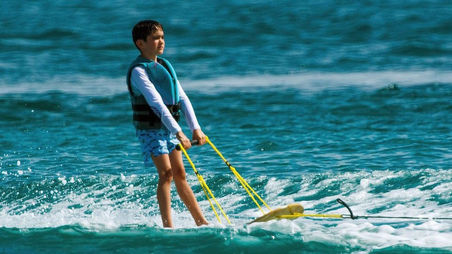 Simon Cowell watches over Eric as he tries water skiing for the first time.