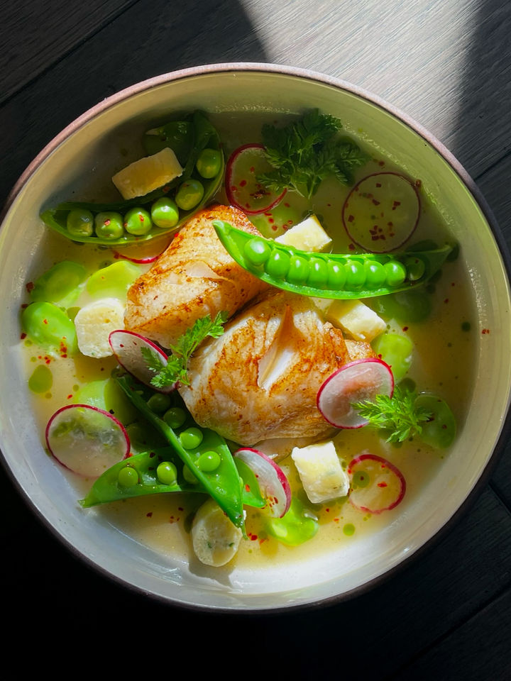 Pacific coast catch in broth with peas and radish