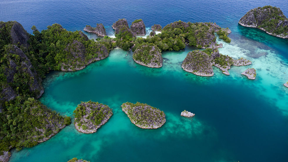 Breathtaking aerial view of the turquoise waters and lush, rocky islets at Piaynemo View Point, Raja Ampat, Indonesia.