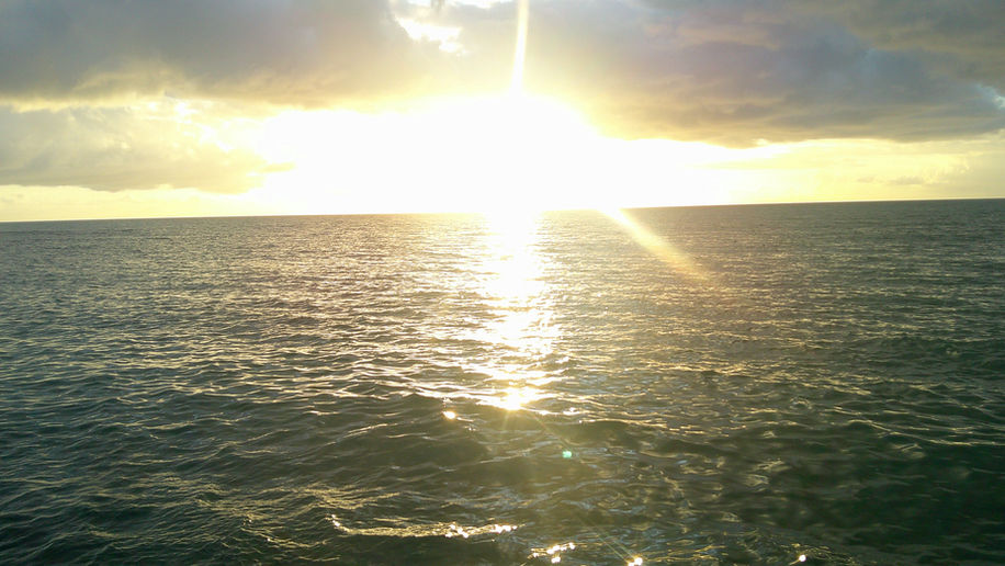 A warm sunset over Puerto Rico's beautiful beach.  Puerto Rico is a small, U.S. island located in the Caribbean Sea.