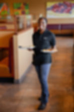 Keke's Waitress Holding Plates in Restaurant