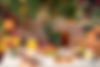 Keke's Breakfast Cafe brunch spread with French toast topped with strawberries and bananas, bacon, eggs, orange juice, and iced tea on an outdoor table