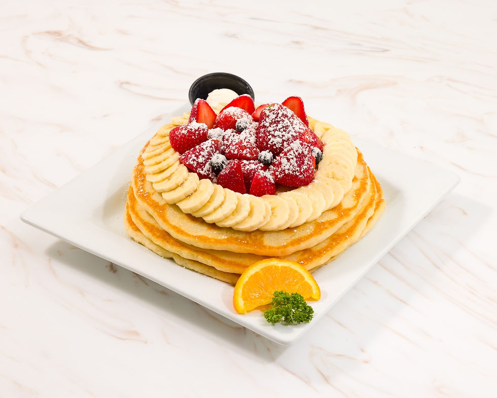 Keke's Breakfast Cafe Florida Pancakes topped with fresh strawberries, blueberries, bananas, and warm syrup