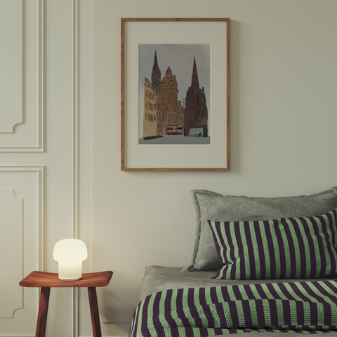 An illustrated print of Edinburgh displayed in a bedroom setting. The art featured displays illustrated monuments of Edinburgh city and a person waiting at a bus stop for the bus that's coming along. Not your typical Edinburgh art print but one that's sure to get people talking. By clicking on this image it takes you to more Edinburgh prints from the Tecari Designs collection.