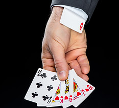partial-view-of-man-holding-playing-cards-with-hid-2024-11-18-06-49-09-utc.jpg