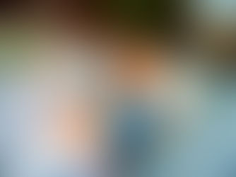 A woman rests on a couch with her dog.