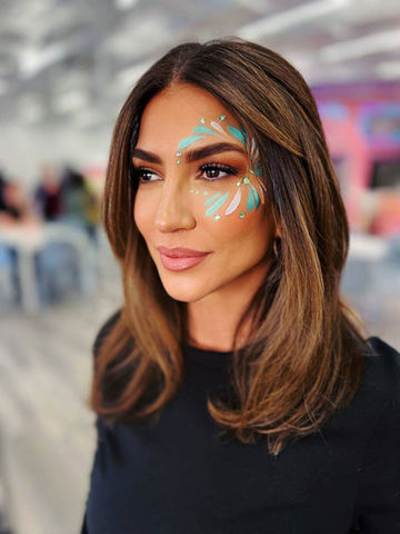 Coachella-style face painting with gems for a music party in Silver Lake, Los Angeles.