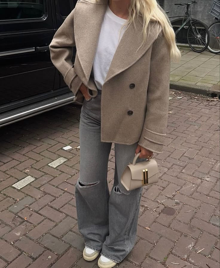 Close-up of a person with glittery green eye makeup, thick lashes, and glossy lips. The background is blurred. Mood is serene and glamorous.
