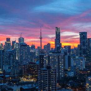 Toronto skyline at dusk, representing how GTA real estate trends influence Simcoe County housing demand and pricing.