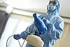 person-in-protective-suit-holding-a-sanitizing-spr-2026-03-24-22-58-54-utc copy.webp