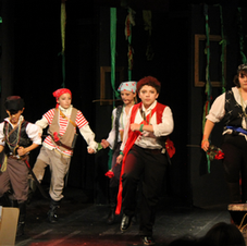 Child actors in pirate costumes performing on stage