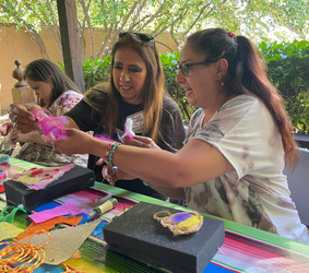 Women crafting colorful art projects
