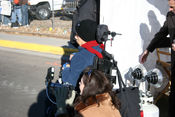 Filmmaker in wheelchair with assistant on set
