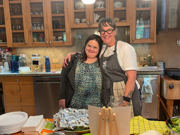 Two women smiling in a kitchen