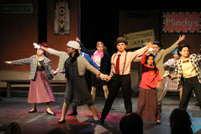 Youthful ensemble performing lively 1940s dance