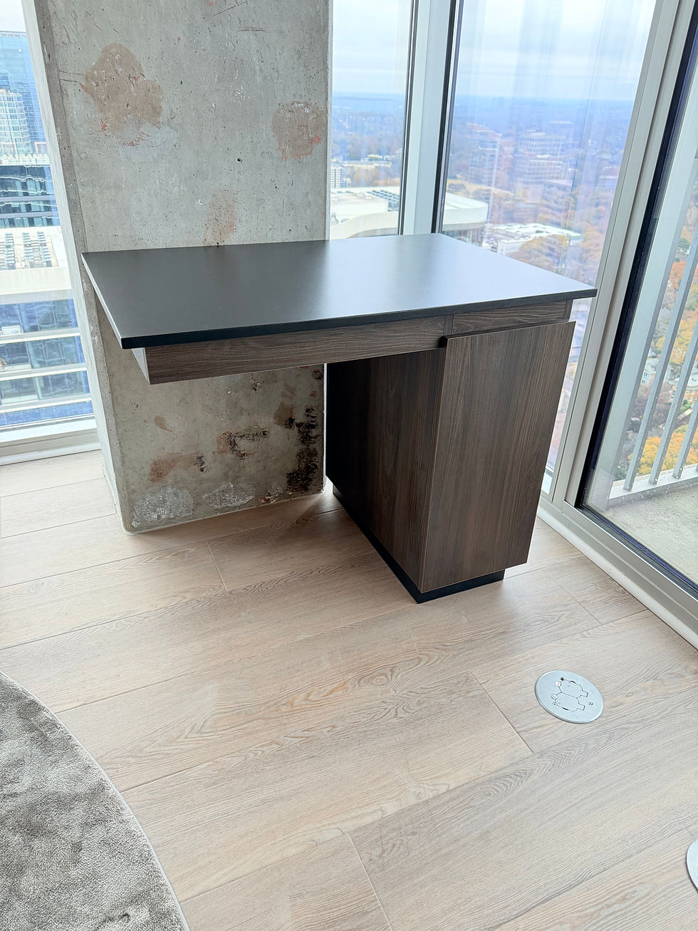 Custom floating desk fitted beside a concrete column and floor-to-ceiling windows in a Midtown Atlanta high-rise.