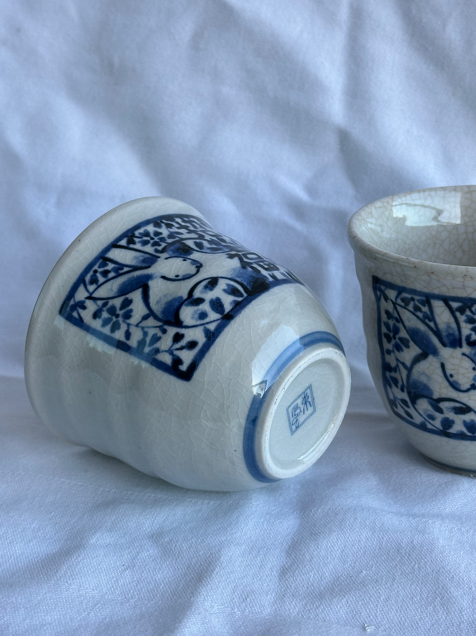 Thumbnail: Pair of Chinese Zodiac Porcelain Tea Cups, Crazed Cream/Blue Design (Rabbit)