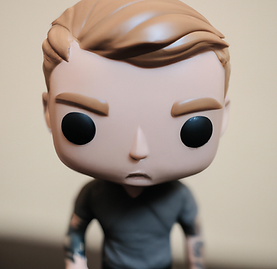 DALL·E 2023-04-26 11.15.49 - 35mm photo of a funko pop! vinyl figure of a young man with m
